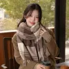 A brown checkered scarf pairs well with a beige coat for women in autumn and winter, providing warmth and fashion details Picture